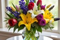 Bouquet of Assorted Flowers Including Red Roses, White Lilies, Purple Irises, and Yellow Tulips - Classic Elegance Royalty Free Stock Photo