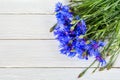 Bouquet of beautiful blue flowers of cornflowers on a white wooden table Royalty Free Stock Photo