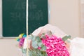 A bouquet of beautiful bright flowers on a school desk on September 1st. The inscription on the school board is the Day of Knowled Royalty Free Stock Photo