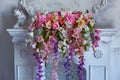 Bouquet of beautiful bright mixed flowers on the white fireplace. Lovely bunch of flowers. Work of the professional florist.