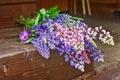 Bouquet of beautiful colorful lupines on a wooden background in a country house