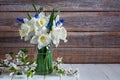 Bouquet of beautiful daffodil flowers in a vase on a wooden table. Still life Royalty Free Stock Photo