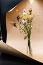 Bouquet of beautiful dried flowers, atmospheric autumn still life. Minimalistic, stylish composition with dry flowers in glass vas