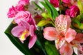 Bouquet of beautiful flowers of lilies, roses close-up on a gray background Royalty Free Stock Photo