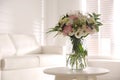 Bouquet of beautiful flowers on table in living room. Interior design Royalty Free Stock Photo