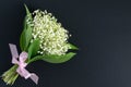 A bouquet of beautiful fragrant white lilies of the valley on a dark background. place for text Royalty Free Stock Photo