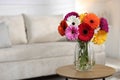 Bouquet of beautiful gerbera flowers on table at home. Space for text Royalty Free Stock Photo