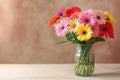 Bouquet of beautiful gerbera flowers in vase on table Royalty Free Stock Photo