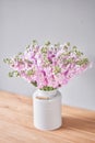 Bouquet of Beautiful lilac mattiola. Spring flowers in vase on wooden table. Flowers delivery. Royalty Free Stock Photo