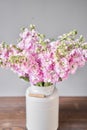 Bouquet of Beautiful lilac mattiola. Spring flowers in vase on wooden table. Flowers delivery. Royalty Free Stock Photo