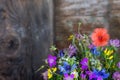 Bouquet of beautiful meadow flowers and poppy on dark wooden background indoors in natural light, still life with wild flowers Royalty Free Stock Photo