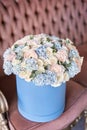 Bouquet of beautiful Mixed flowers in blue box. European floral shop. Floral bunch in round box. Excellent garden
