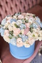 Bouquet of beautiful Mixed flowers in blue box. European floral shop. Floral bunch in round box. Excellent garden