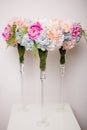Bouquet of beautiful mixed flowers in a vase on a high stem. Lovely bunch of flowers. Work of the professional florist. Wedding or