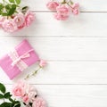 Bouquet of beautiful pink roses and gift in pink packing Royalty Free Stock Photo