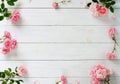 Bouquet of beautiful pink roses and gift in pink packing on white wooden background.Top view.Copy space Royalty Free Stock Photo