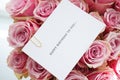 Bouquet of beautiful pink roses with a greeting card, clsoe-up. Top view