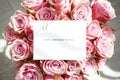 Bouquet of beautiful pink roses with a greeting card, clsoe-up. Top view