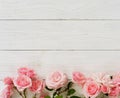 Bouquet of beautiful pink roses on white wooden background.Top view.Copy space banner Royalty Free Stock Photo