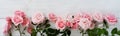 Bouquet of beautiful pink roses on white wooden background.Top view.Copy space banner Royalty Free Stock Photo