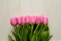 Bouquet of beautiful pink tulips on white wooden background. Top view. Copy space Royalty Free Stock Photo