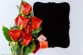 Bouquet of beautiful red roses with ring and mockup black board isolated on white background Royalty Free Stock Photo