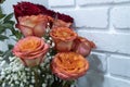 Bouquet of beautiful roses against a white brick wall. St valentines bouquet