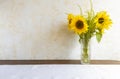 A bouquet of beautiful sunflowers in a glass vase on the table. Floral design concept. Royalty Free Stock Photo