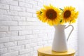 Bouquet of beautiful sunflowers on table near white brick wall. Space for text Royalty Free Stock Photo