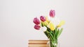 Bouquet of beautiful tulips. Fresh Tulip Bouquet and books on white background. Spring, International Womens Day concept