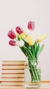 Bouquet of beautiful tulips. Fresh Tulip Bouquet and books on white background. Spring, International Womens Day concept