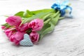 Bouquet of beautiful tulips and small cotton heart on light wooden background Royalty Free Stock Photo