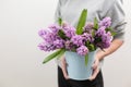 Bouquet of Beautiful violet and lilac hyacinths. Spring flowers in vase in woman hand. bulbous plant. Horizontal photo Royalty Free Stock Photo