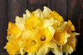 Bouquet of beautiful yellow daffodils near wall, closeup