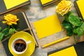 Bouquet of beautiful yellow roses with stack of old vintage books and hot coffee on wooden background Royalty Free Stock Photo