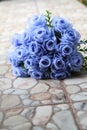 Bouquet of blue rose lying on grey road Royalty Free Stock Photo