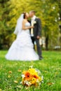 A bouquet for the bride on the background of kissing pair Royalty Free Stock Photo