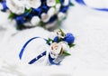 A bouquet of the bride from white and blue roses and wedding rings from gold Royalty Free Stock Photo