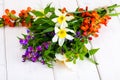 Bouquet of bright freshly cut flowers on wooden table