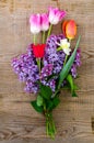 Bouquet of bright freshly cut flowers on wooden table