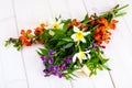 Bouquet of bright freshly cut flowers on wooden table