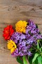 Bouquet of bright freshly cut flowers on wooden table