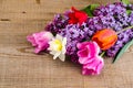 Bouquet of bright freshly cut flowers on wooden table