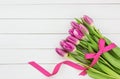 Bouquet of bright pink tulips on white wooden background. Top view Royalty Free Stock Photo