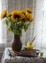 A bouquet of bright sunflowers in a clay jug on the background of a lace curtain Royalty Free Stock Photo