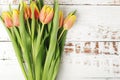 A bouquet of bright tulip at white wooden background with copy space