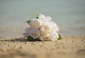 Bouquet bunch of flowers on a tropical sandy beach Royalty Free Stock Photo