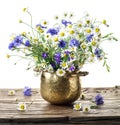 Bouquet of chamomiles and corn flowers in the vase on the wooden table Royalty Free Stock Photo