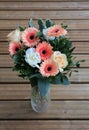 Bouquet of Colorful Mixed Flowers in a Glass Vase on a Wooden Floor Royalty Free Stock Photo