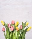 Bouquet of colorful spring tulips on wooden rustic background top view close border ,place for text